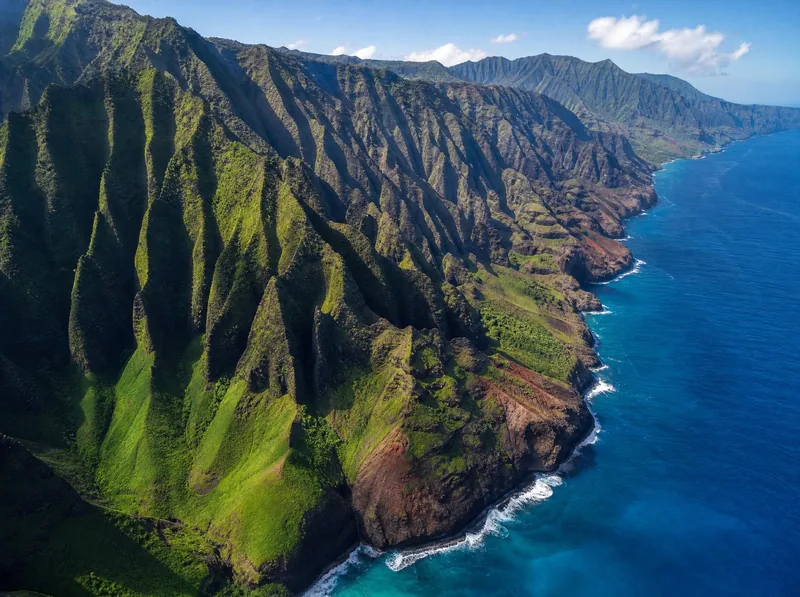 The fluted green cliffs of the Nā Pali Coast from the air, a stretch of Kauaʻi with no road access